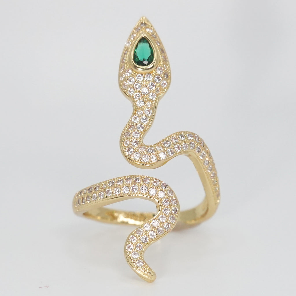A dazzling array of shimmering stones with a captivating green gemstone at its head, epitome of sophistication.