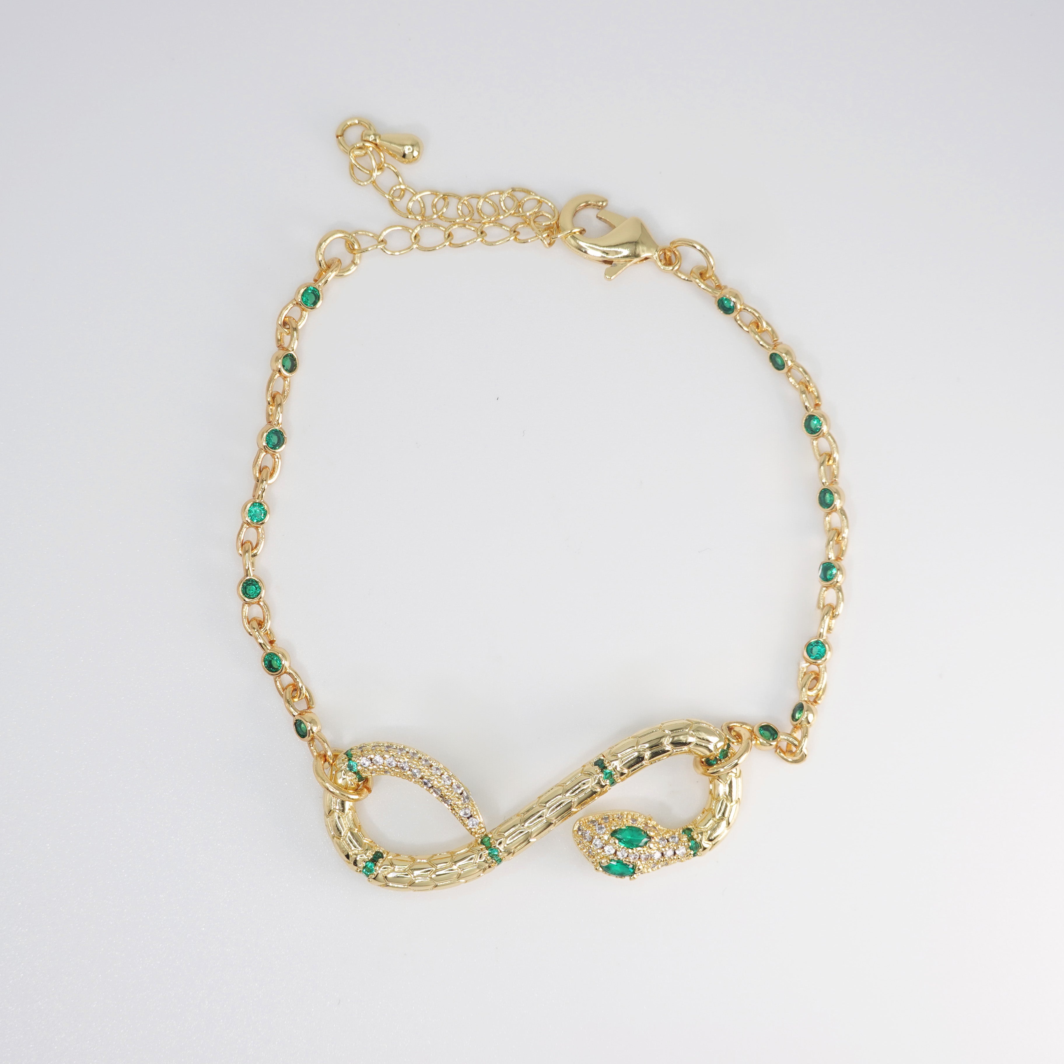 Violet Bracelet: Serpent-shaped design adorned with striking green stones, epitome of allure and sophistication.