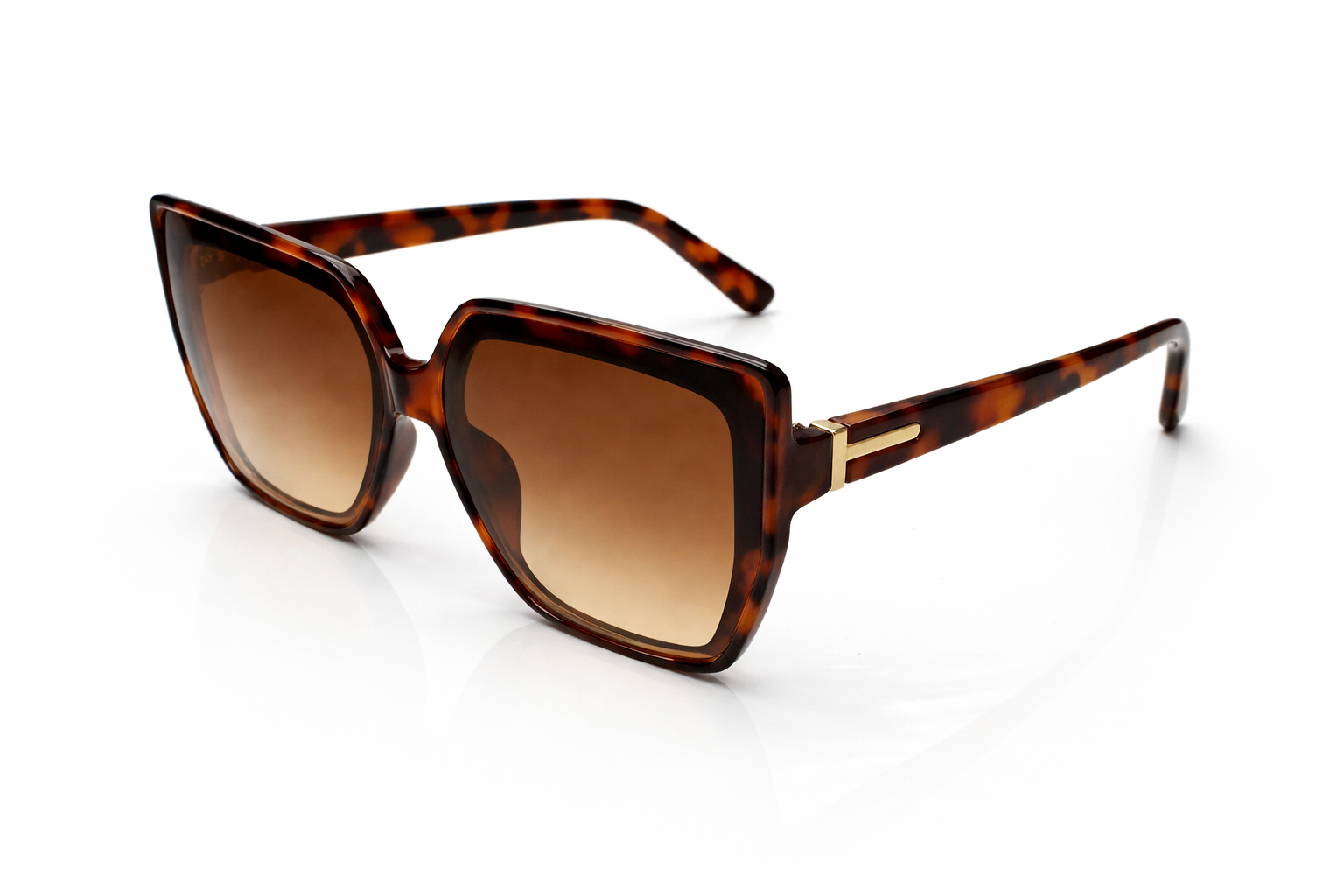 Sunglasses with tortoiseshell frame and brown lenses on a white background