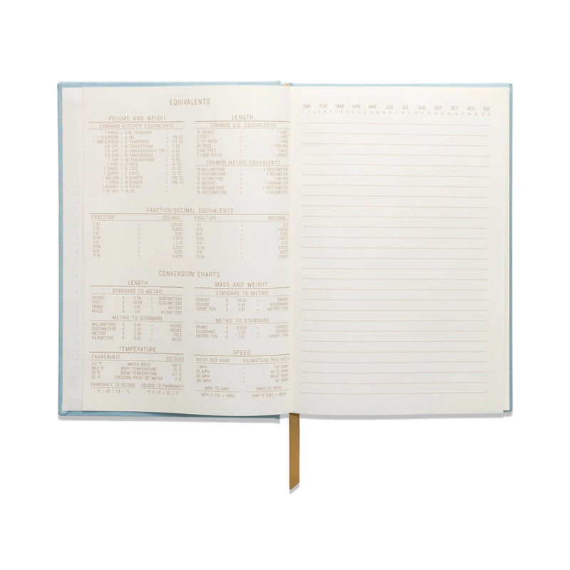 Image of the 'Ellipse Spot Journal' with a green suede cloth cover, gold geometric design, and gold ribbon bookmark.
