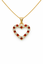 Heart-shaped pendant with red and clear stones on a gold chain against a white background