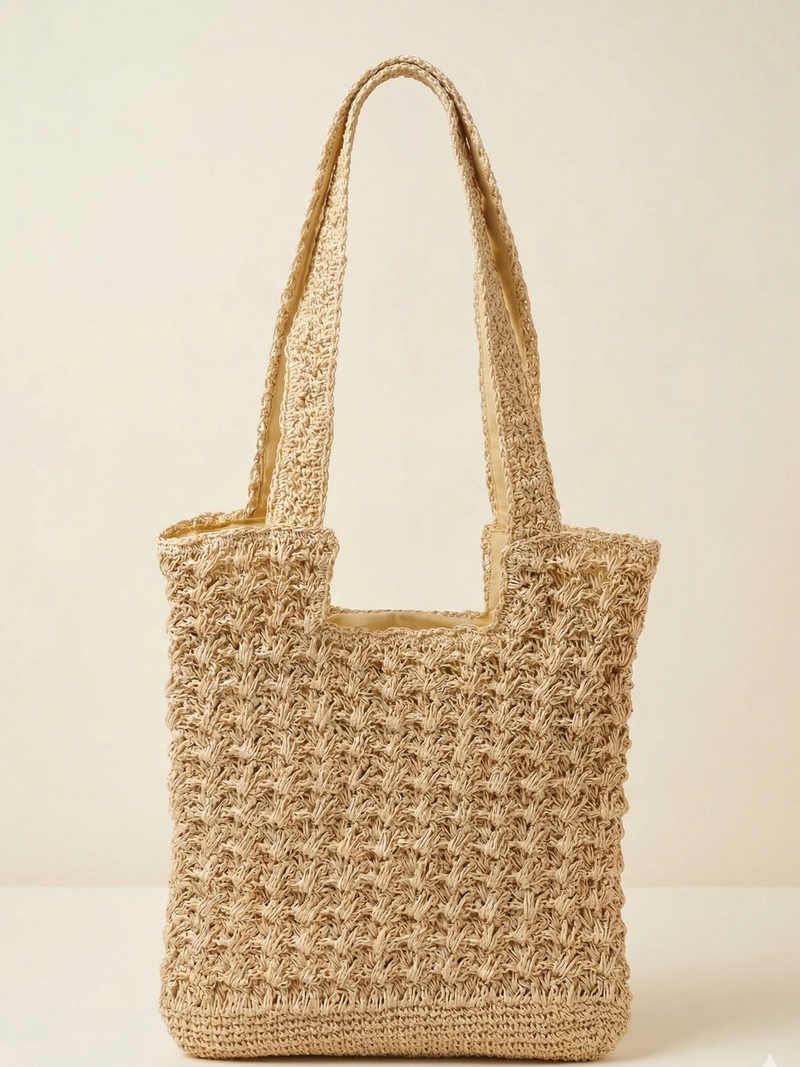 Woven straw tote bag on a light beige background