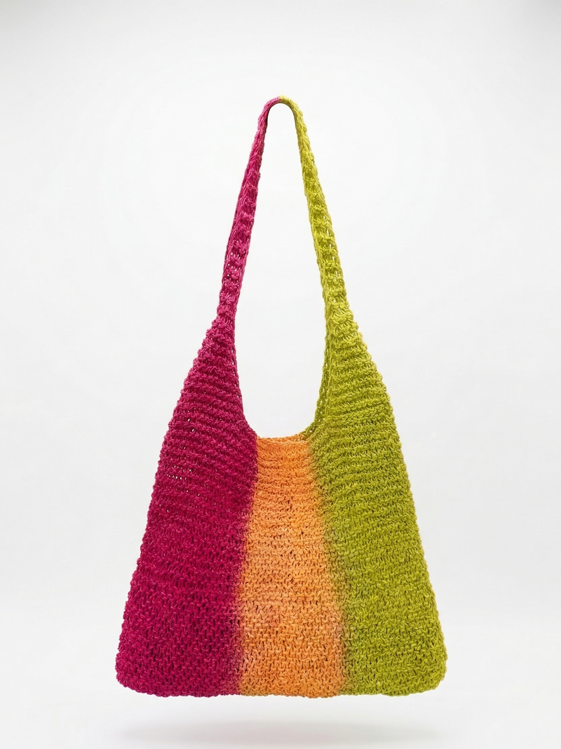 Colorful crocheted bag with a gradient from pink to green on a white background