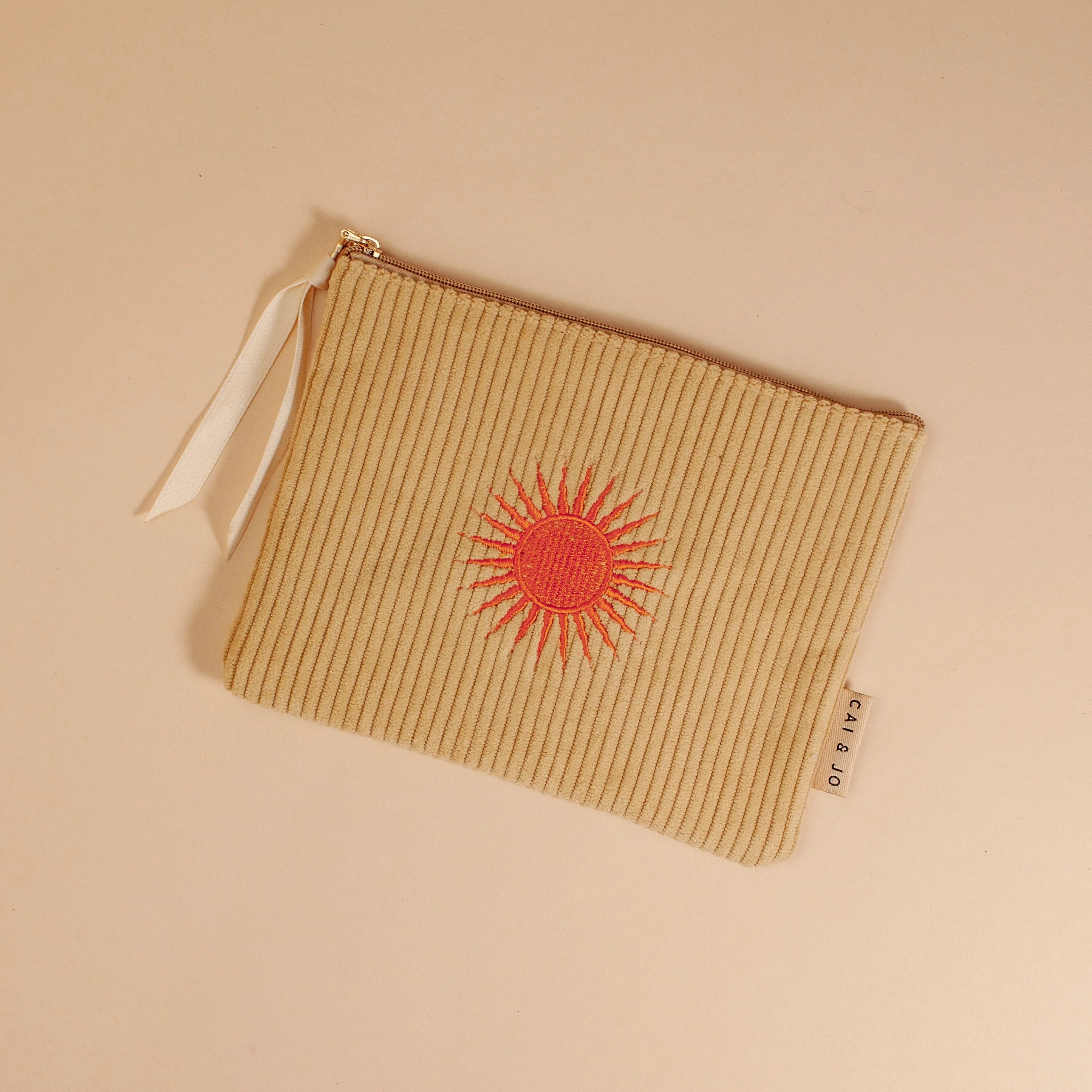 'Solis Corduroy Pouch' crafted from plush corduroy, featuring a sunny motif