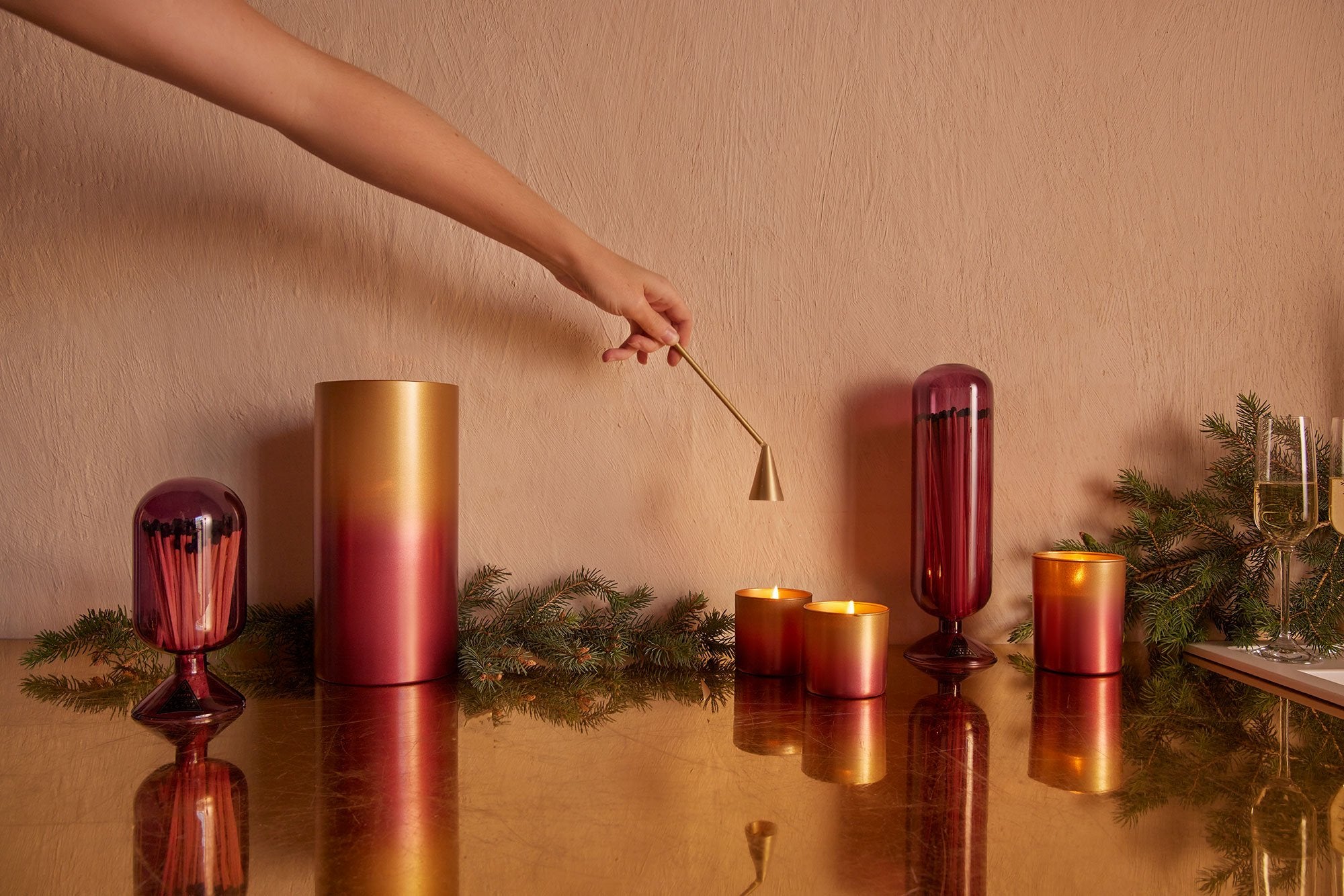 Skeem Design golden candle snuffer with a minimalist design, perfect for safely extinguishing candles.