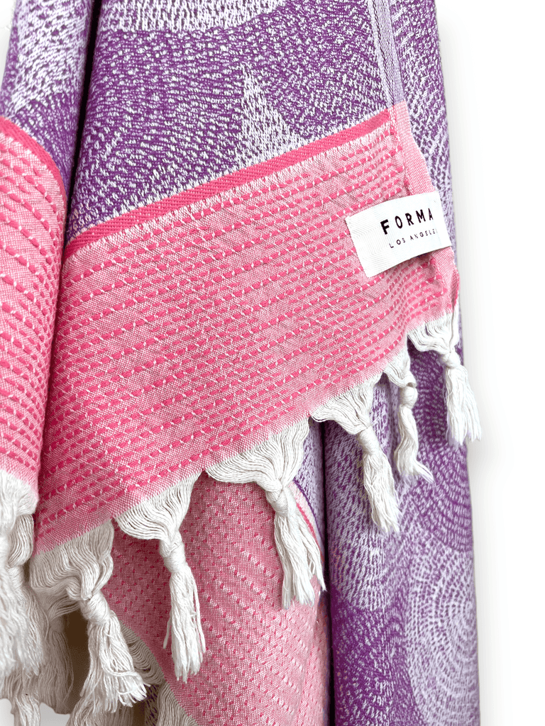 A set of Forma Towels from the Shell Collection, highlighting their soft, absorbent texture, ideal for both beach and home use.