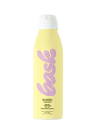 Hand holding Bask SPF 50 Sunscreen Spray, showing the spray function against a sunny beach scene.