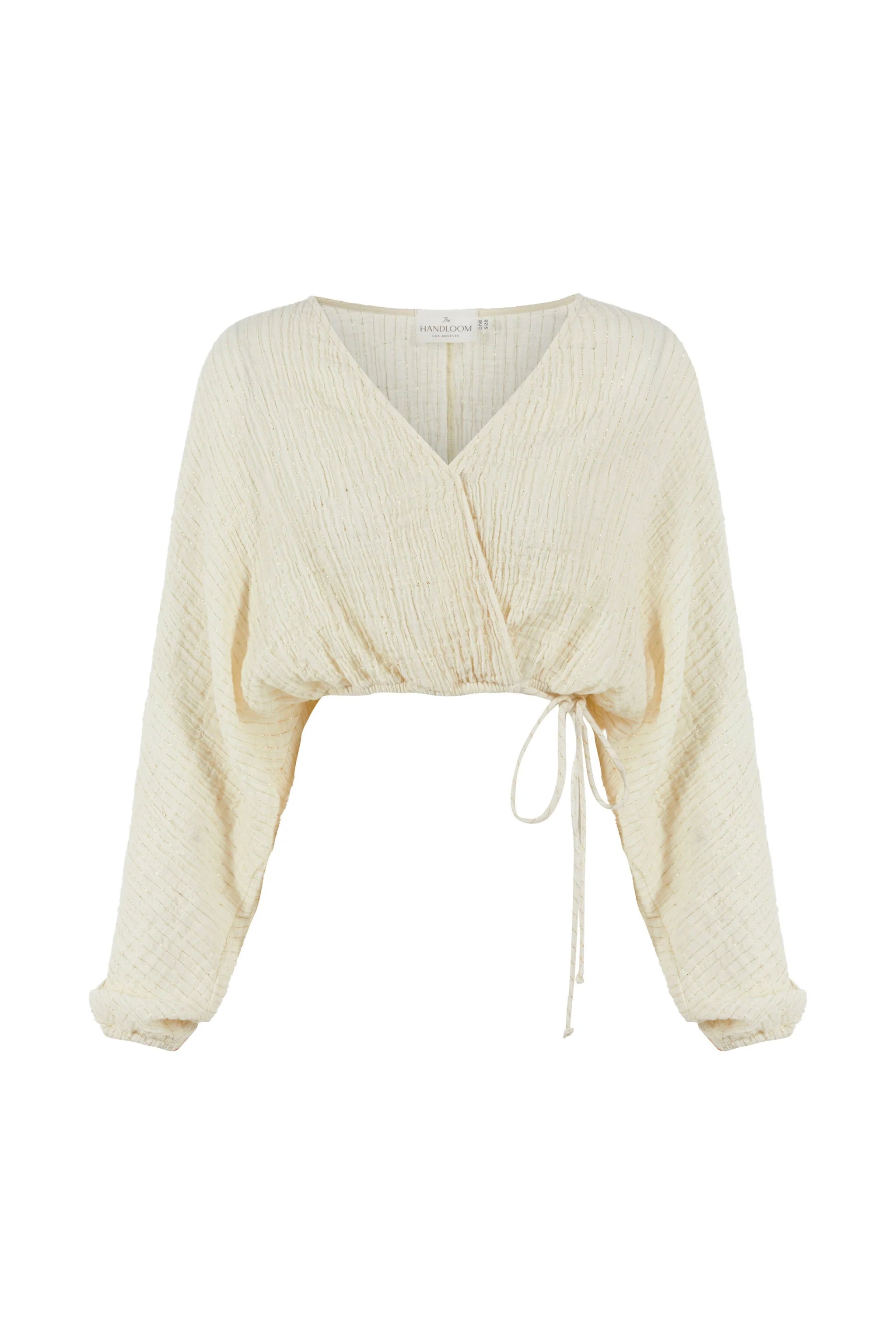 Siena Top displayed on a hanger, showcasing its wide sleeves and the unique V-shaped front drape with a hidden optional closure.