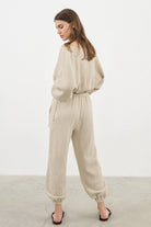 Siena Top displayed on a hanger, showcasing its wide sleeves and the unique V-shaped front drape with a hidden optional closure.