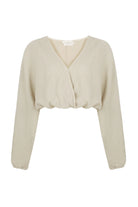 Siena Top displayed on a hanger, showcasing its wide sleeves and the unique V-shaped front drape with a hidden optional closure.