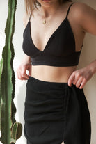 A woman wearing the Sundown Top, showcasing its relaxed fit, short sleeves, and flattering neckline, a versatile and stylish option for any occasion.