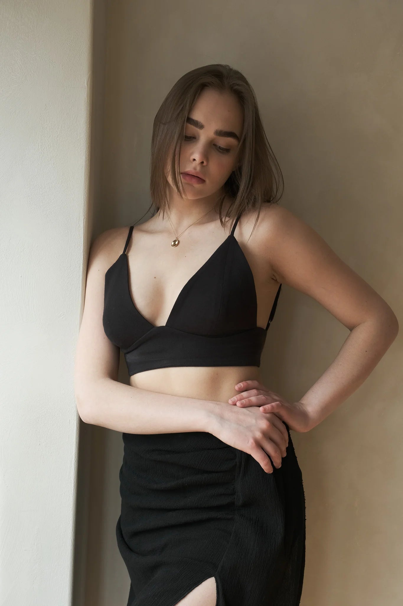 A woman wearing the Sundown Top, showcasing its relaxed fit, short sleeves, and flattering neckline, a versatile and stylish option for any occasion.