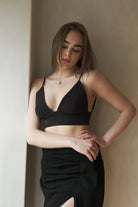 A woman wearing the Sundown Top, showcasing its relaxed fit, short sleeves, and flattering neckline, a versatile and stylish option for any occasion.