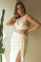 A woman wearing the Sundown Top, showcasing its relaxed fit, short sleeves, and flattering neckline, a versatile and stylish option for any occasion.