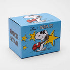White ceramic mug with a red handle featuring a cool character playing a guitar, surrounded by yellow stars, with "Rock Star" printed on the back.