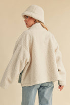 Back view of a sherpa-lined jacket paired with a fleece bucket hat.
