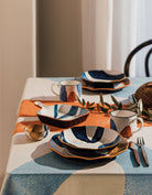 Canvas Pinch Bowls with abstract mustard yellow, navy blue, and light blue patterns.