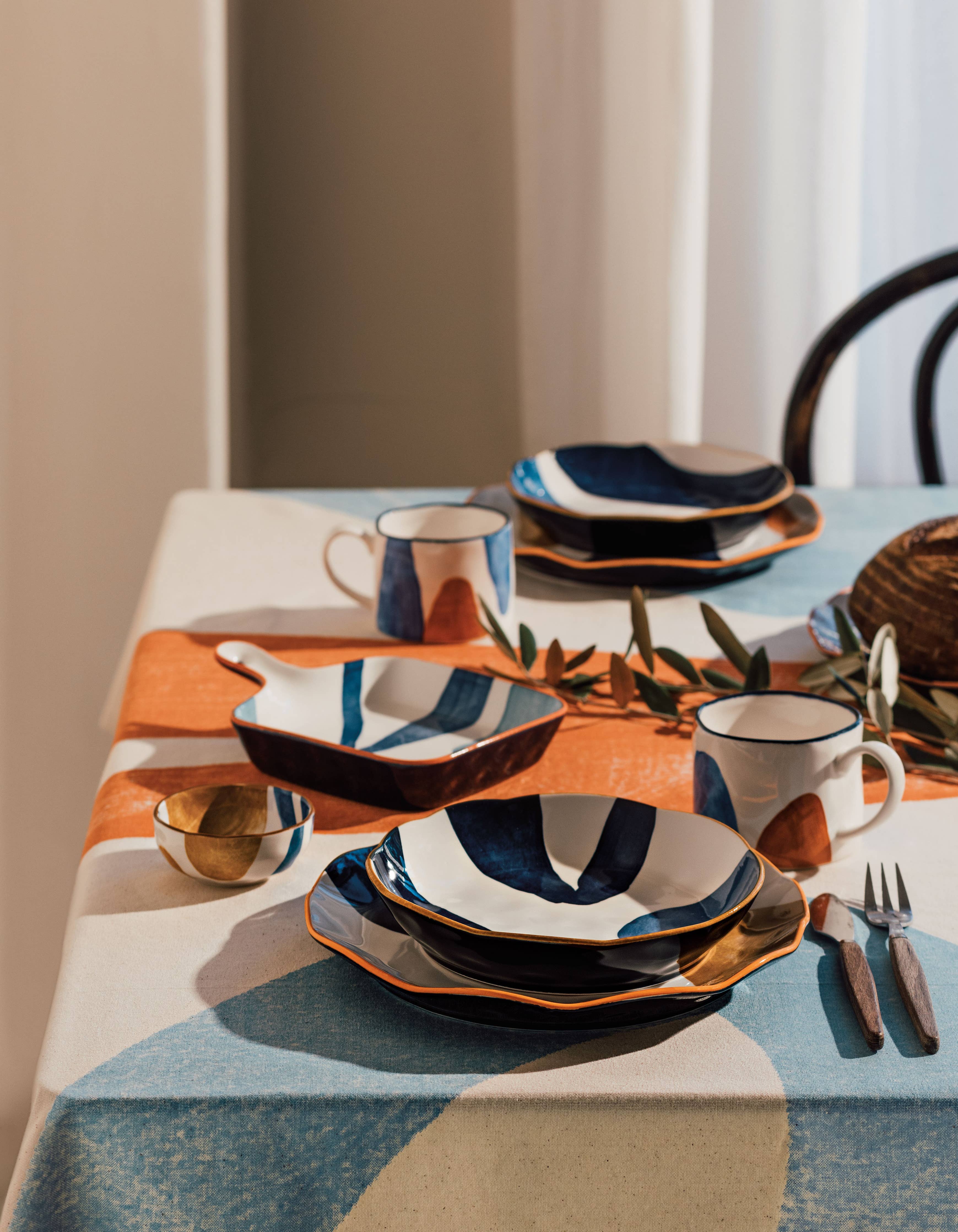 Canvas Pinch Bowls with abstract mustard yellow, navy blue, and light blue patterns.