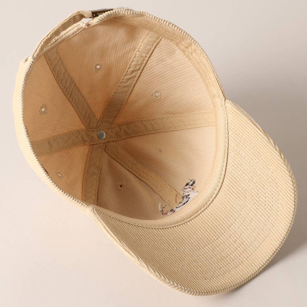 Beige corduroy baseball cap with embroidered beagle dog design on the front.