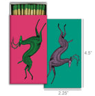 Artistic matchbox with abstract deer illustrations on vibrant pink and green backgrounds.