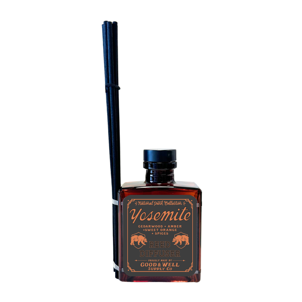 Yosemite reed diffuser with amber glass bottle and black reeds by Good & Well Supply Co., featuring cedarwood, amber, and orange.