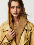 Woman wearing a Sahara Sky Hooded Jacket with a zip-up front, textured waffle knit, and button detailing in blue and brown tones.