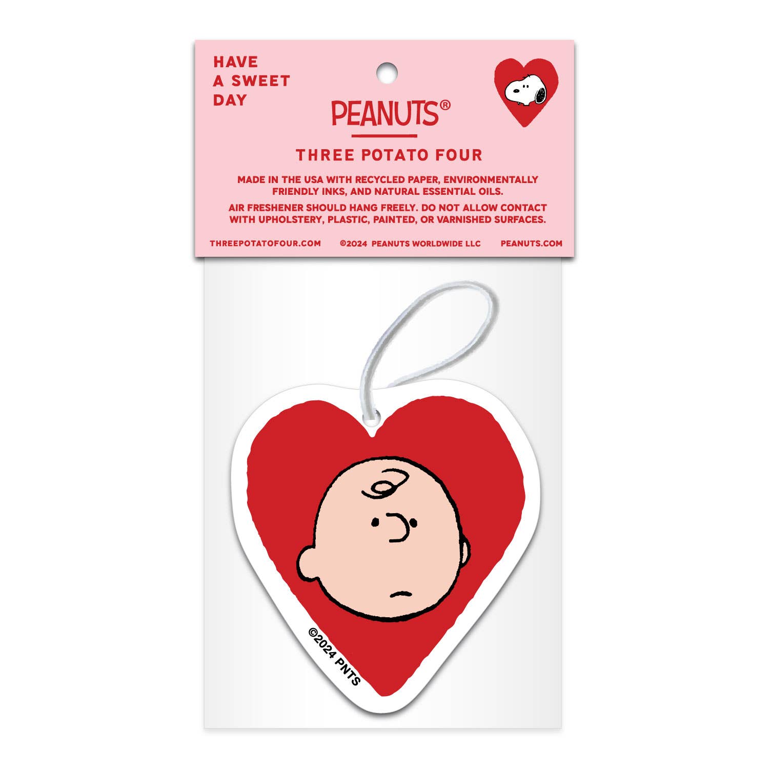 Peanuts® Valentine heart-shaped air freshener featuring Snoopy’s face in a red heart, infused with lavender scent, packaged with a pink and white card.