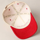 Corduroy trucker baseball cap with "American Honey" embroidered in red on cream and red fabric.