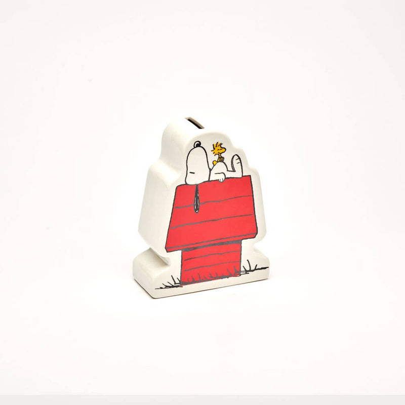 Snoopy and Woodstock ceramic coin bank with Snoopy lying on his red doghouse.
