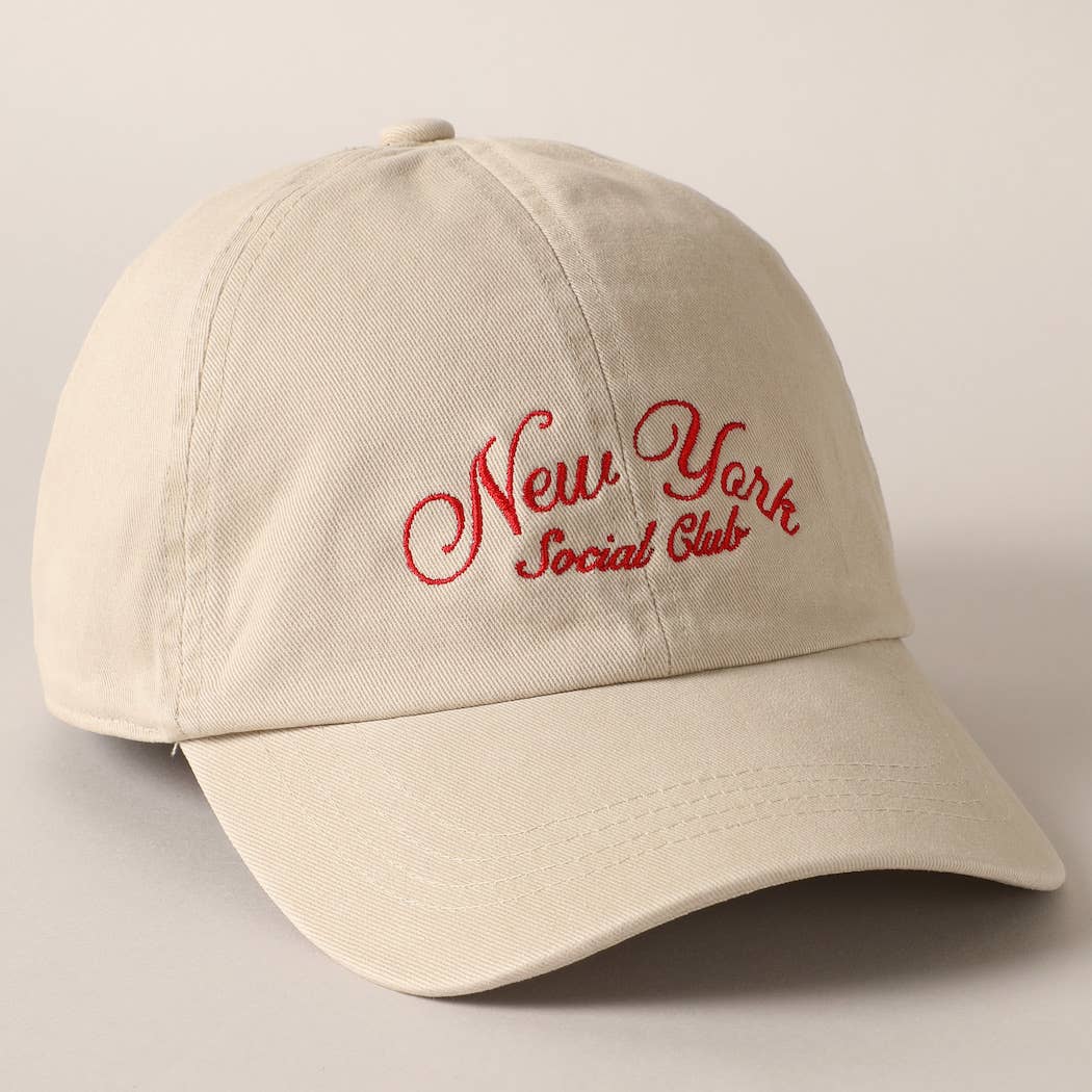 Beige and navy New York Social Club embroidered baseball caps with curved brims.