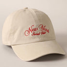 Beige and navy New York Social Club embroidered baseball caps with curved brims.