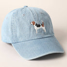 Light blue denim cap with a dog embroidery on a beige background