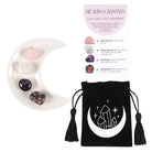 Love Crystal Set featuring a crescent moon trinket dish, rose quartz, clear quartz, amethyst, and rhodonite stones, displayed with a matching information card and a printed drawstring pouch.