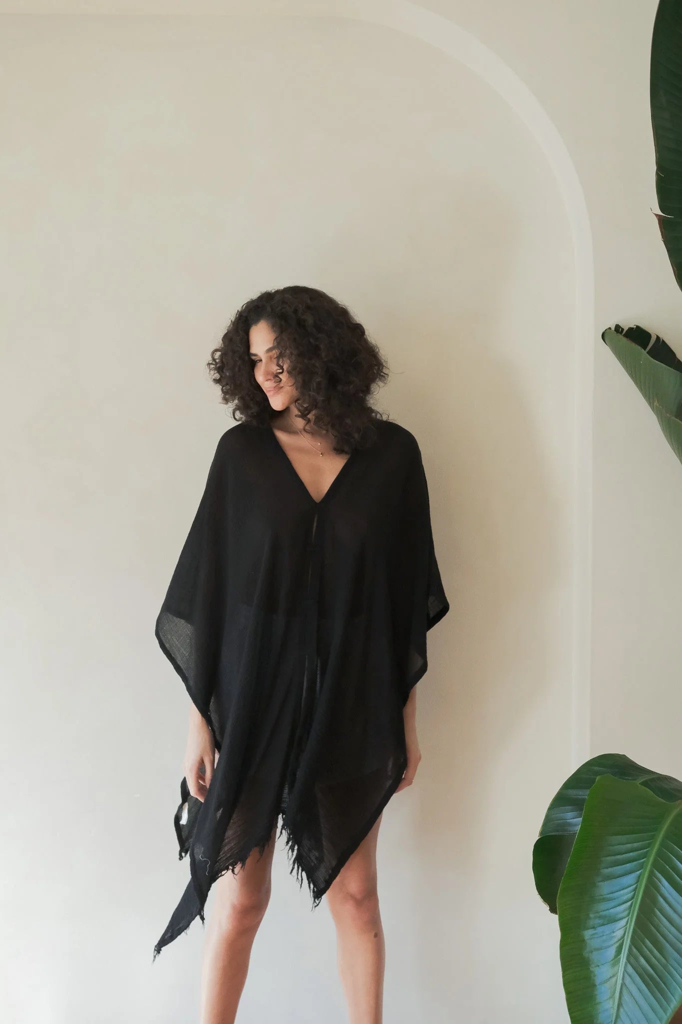 A woman gracefully wearing the Ava Kimono, showcasing its flowing silhouette, delicate patterns, and high-quality fabric.