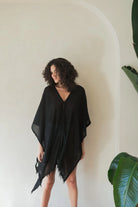 A woman gracefully wearing the Ava Kimono, showcasing its flowing silhouette, delicate patterns, and high-quality fabric.