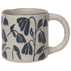 Ceramic mug with blue leaf patterns on a white background