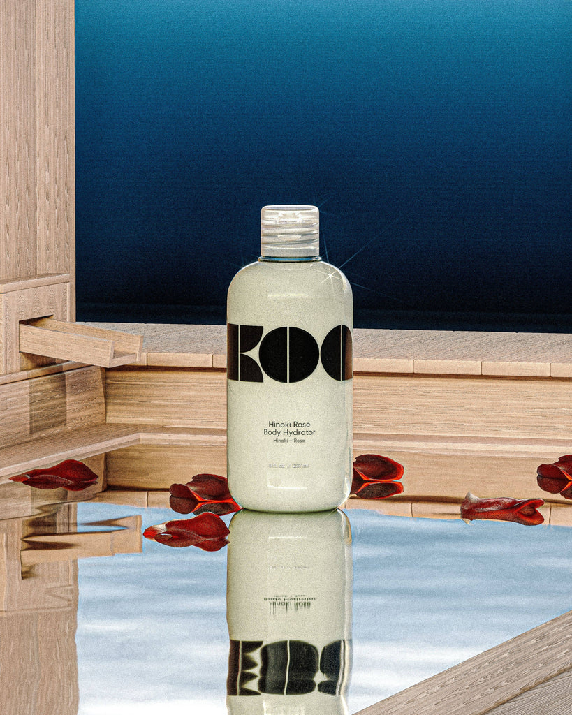 Bottle of Koa Hinoki Rose Body Hydrator, featuring a minimalist design with bold black lettering on a white background.