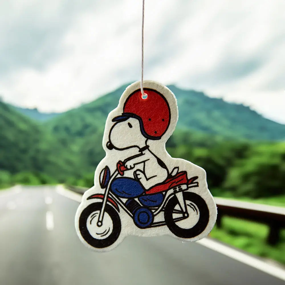 Peanuts Snoopy Motorcycle Air Freshener - Snoopy cruising on a motorcycle. A whimsical car accessory with a refreshing scent.