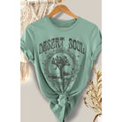 "Desert Soul" graphic t-shirt featuring a Joshua Tree design, available in sage green and charcoal gray, displayed on hangers.