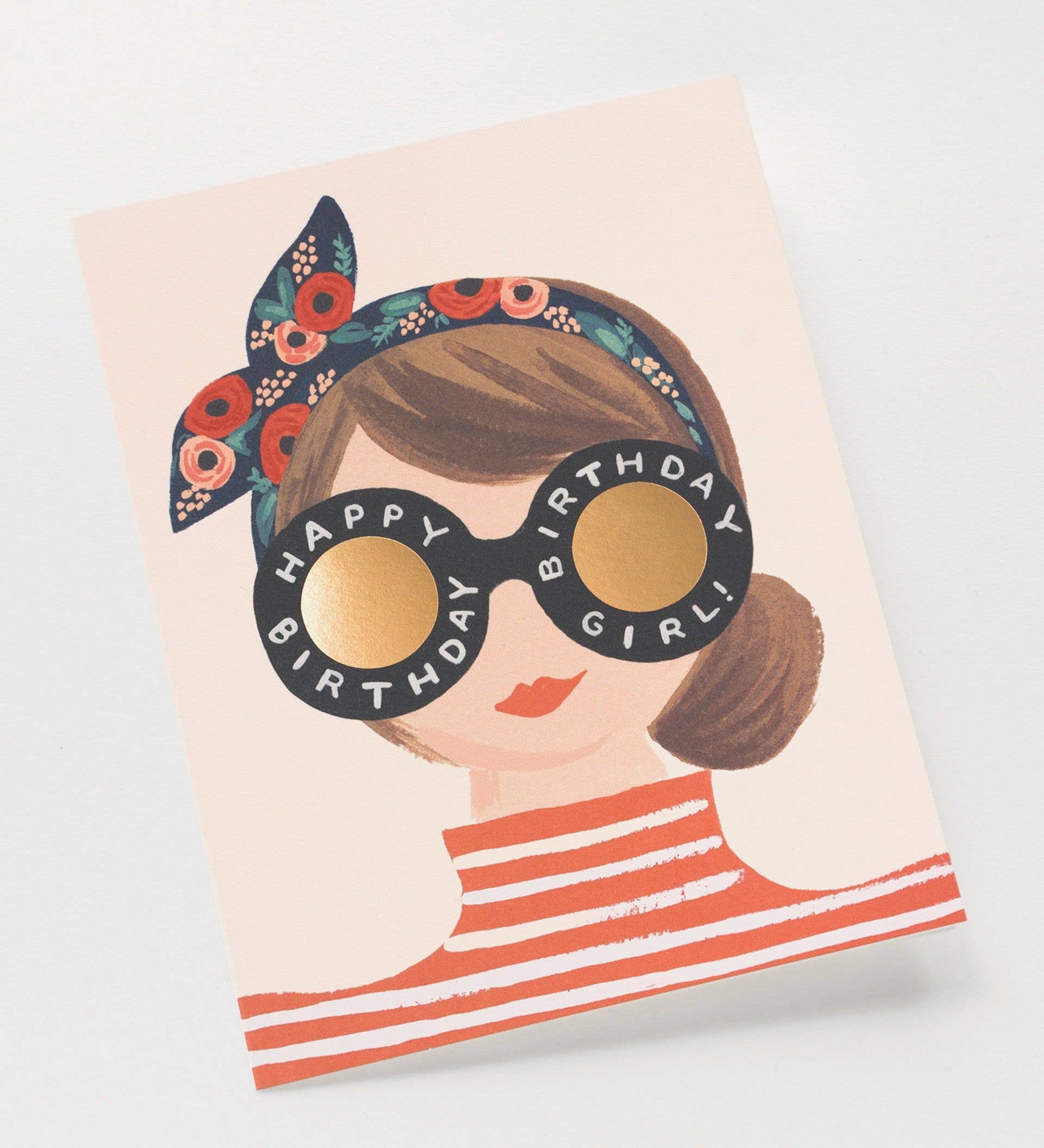A stylish birthday card featuring an illustration of a woman with a floral headband and sunglasses that read "Happy Birthday Girl!"