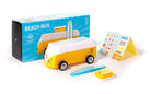 Yellow and white toy bus with packaging and accessories on a white background
