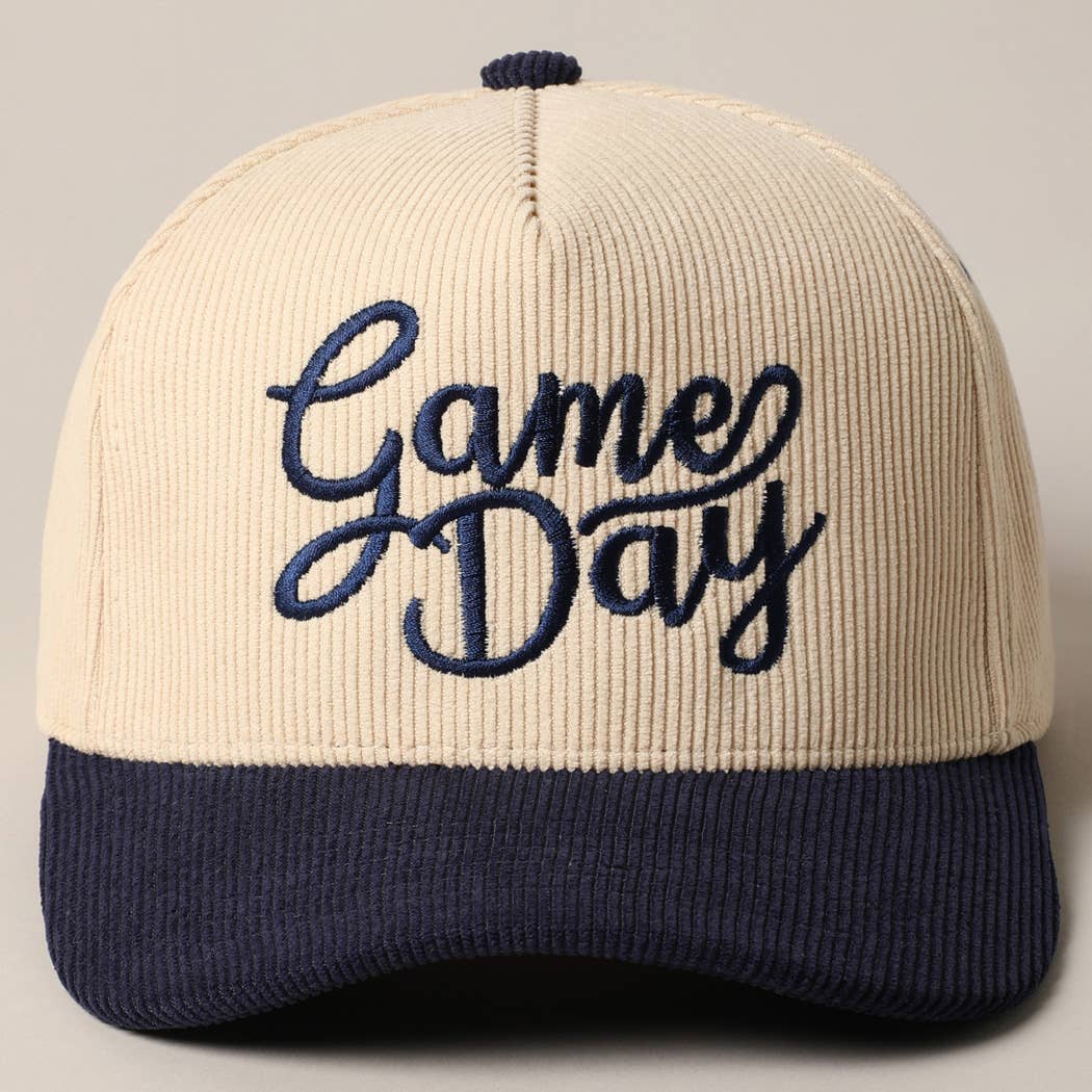 Corduroy trucker baseball cap with "Game Day" embroidered in navy on cream and navy fabric.