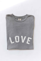 Ivory "LOVE" graphic t-shirt with bold red vintage-style lettering, made from soft cotton for a relaxed and comfortable fit.