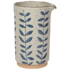 Handcrafted ceramic pitcher with a speckled glaze and blue leaf pattern, ideal for serving drinks or as a decorative vase.