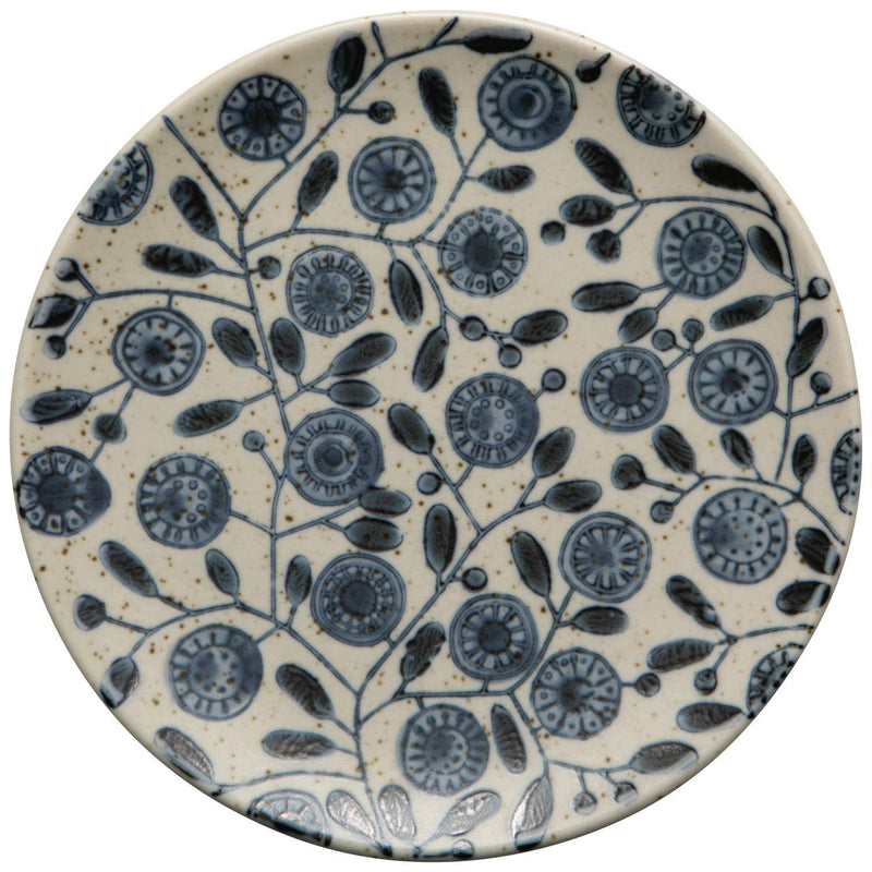 Ceramic plate with blue floral pattern on a beige background