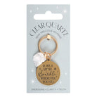 Clear quartz crystal keychain with gold-tone pendant and inspirational message on display card.