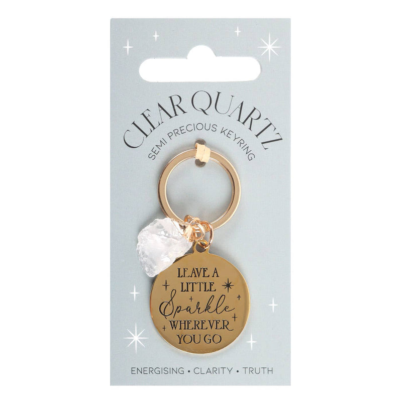 Clear quartz crystal keychain with gold-tone pendant and inspirational message on display card.