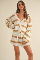 Woman wearing a cream and camel striped knit set with button cardigan and drawstring shorts.
