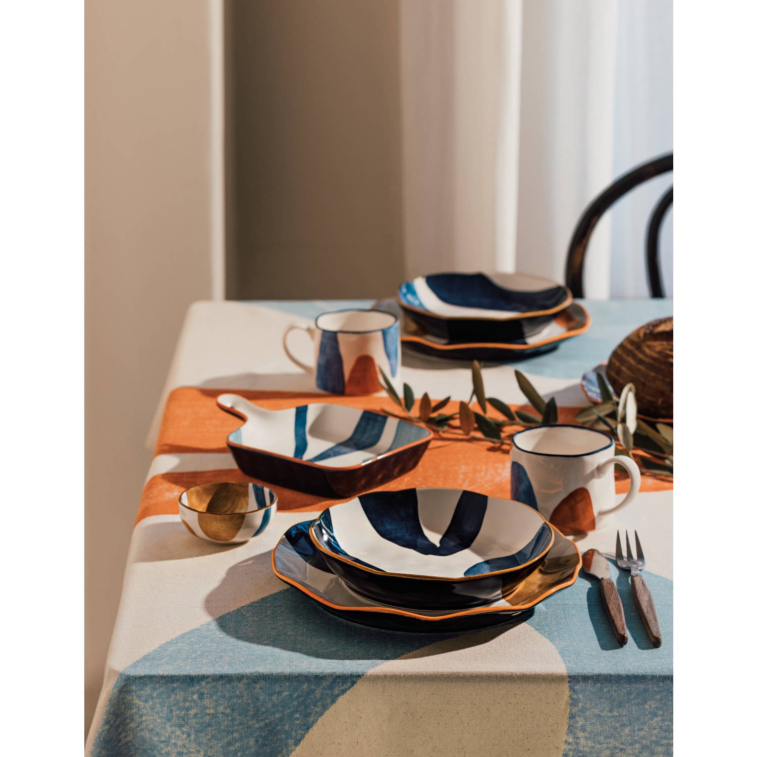Canvas Mug with abstract mustard yellow, navy blue, and light blue patterns.
