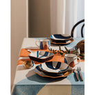 Canvas Stamped Plate with abstract mustard yellow, navy blue, and light blue patterns.